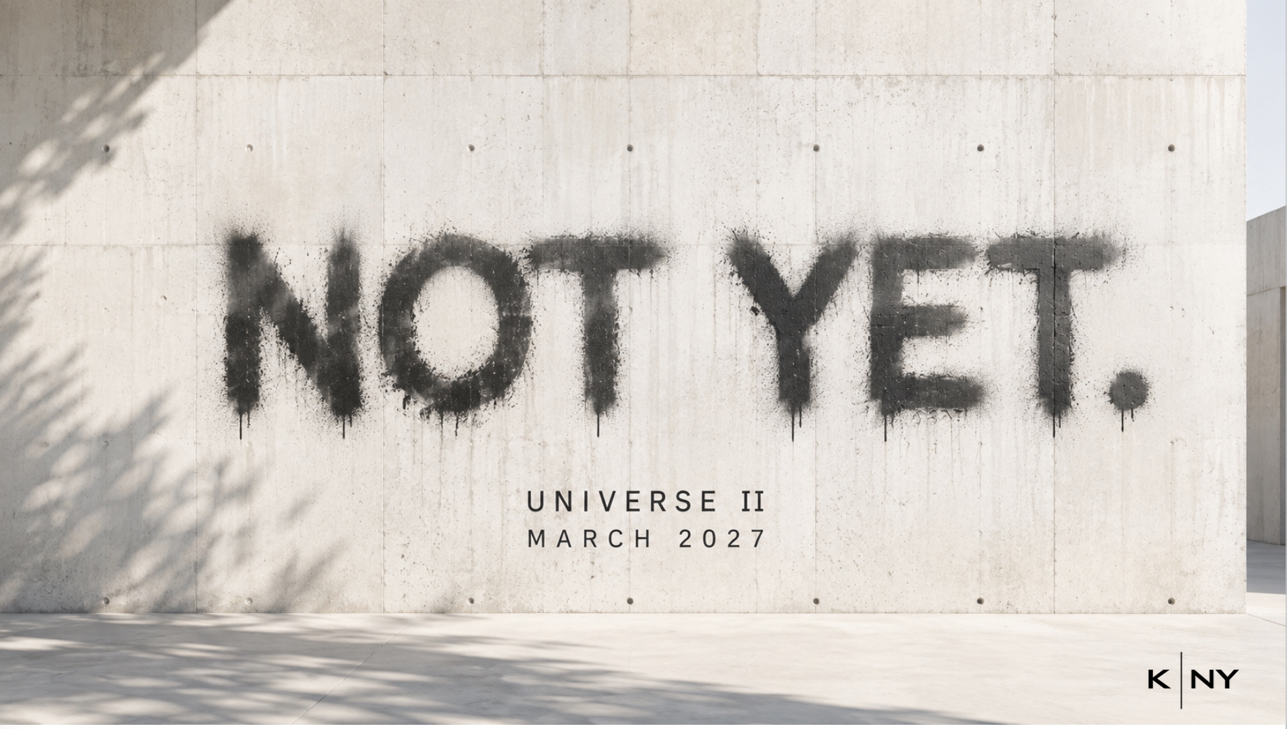 NOT YET. — K-NY Universe II, coming March 2027, displayed on a concrete wall.